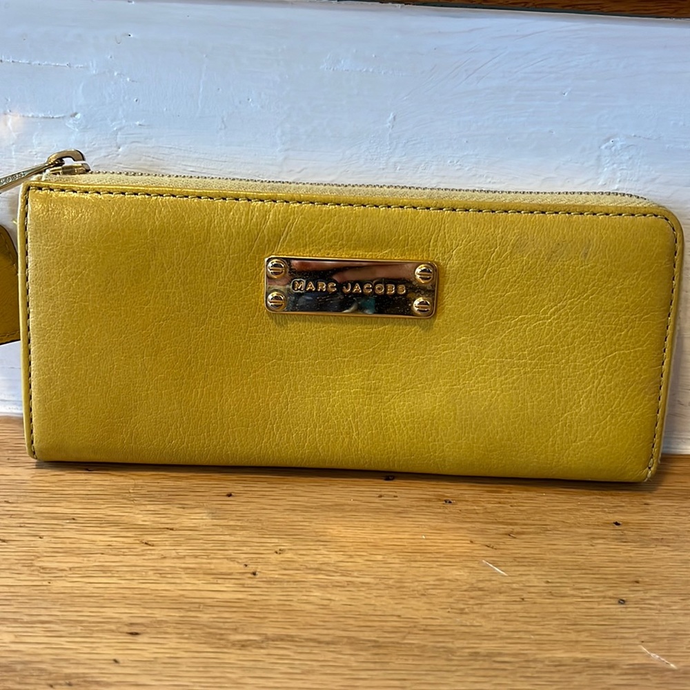 MARC JACOBS mustard yellow zippered wallet.